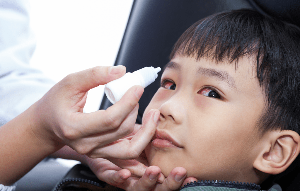 child with pink eye getting customised eye drops